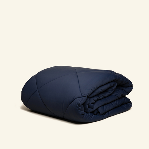 The All-season UltraCool Comforter folded in the Navy color