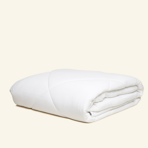 The Lightweight UltraCool Comforter folded in the white color