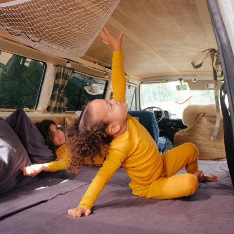 Two young children playing in the back of a van with Slumber Cloud Flannel Sheets