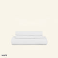 A neatly folded set of Slumber Cloud Performance Sheets in white on a cream background