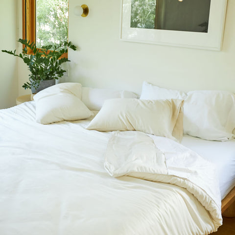 A simple and messy bed made with Slumber Cloud products.